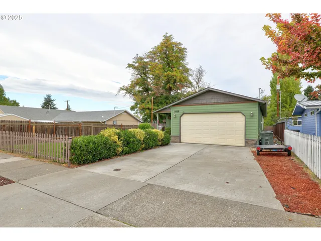 a view of a house with a yard and garage