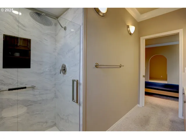 a view of a big room with windows and chandelier