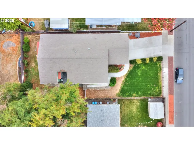 an aerial view of a house with a yard and lake view