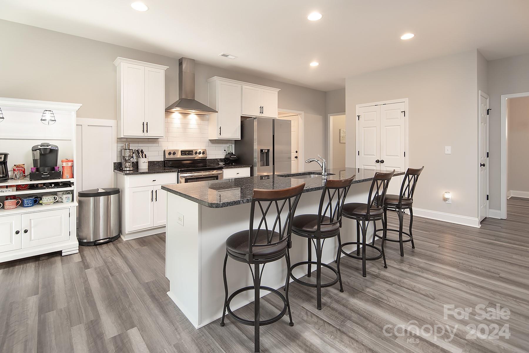 3000 Penninger Road Concord, NC 28025 - Photo 15 of 48 a kitchen with stainless steel appliances a dining table chairs microwave and sink