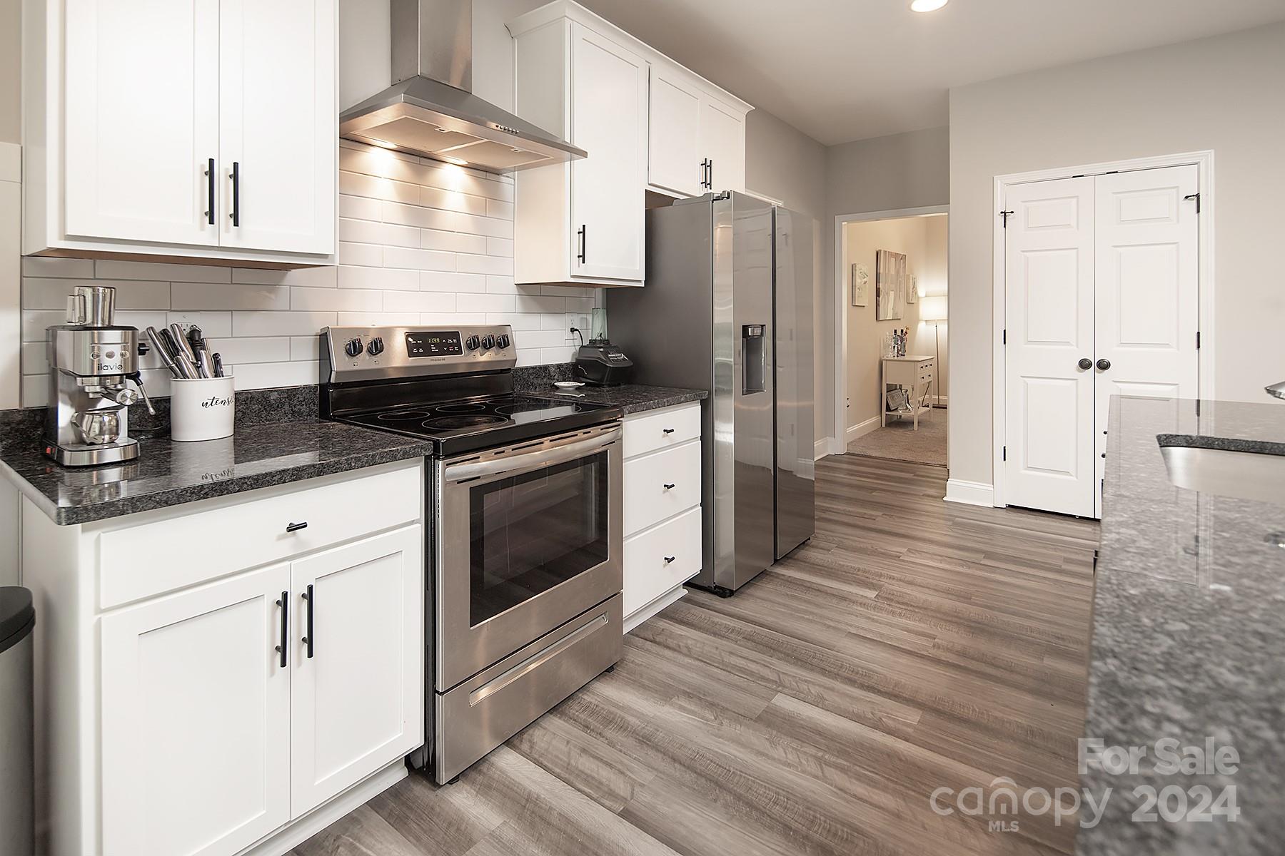 3000 Penninger Road Concord, NC 28025 - Photo 16 of 48 a kitchen with stainless steel appliances granite countertop a stove a refrigerator and a sink
