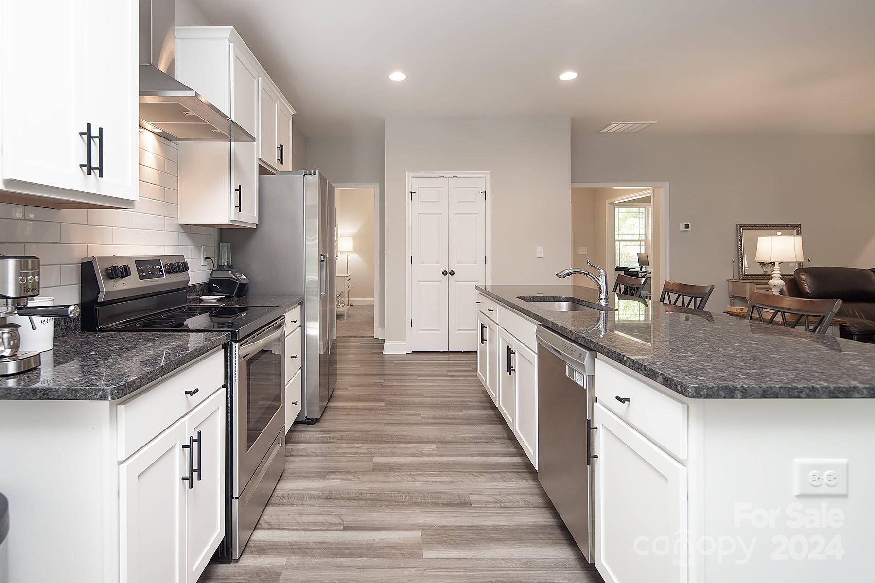 3000 Penninger Road Concord, NC 28025 - Photo 17 of 48 a large kitchen with stainless steel appliances granite countertop a lot of counter space and a sink