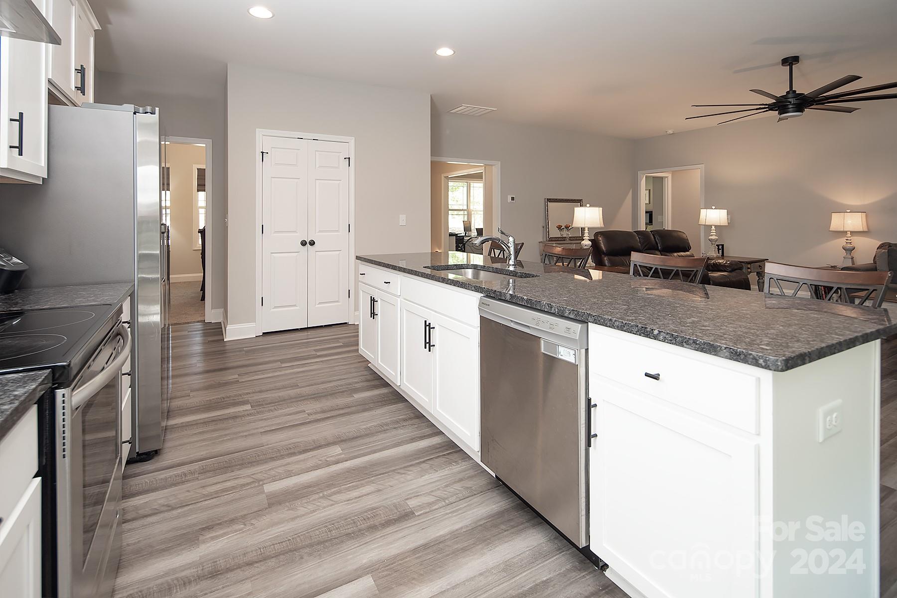 3000 Penninger Road Concord, NC 28025 - Photo 18 of 48 a kitchen with granite countertop a sink stove and refrigerator