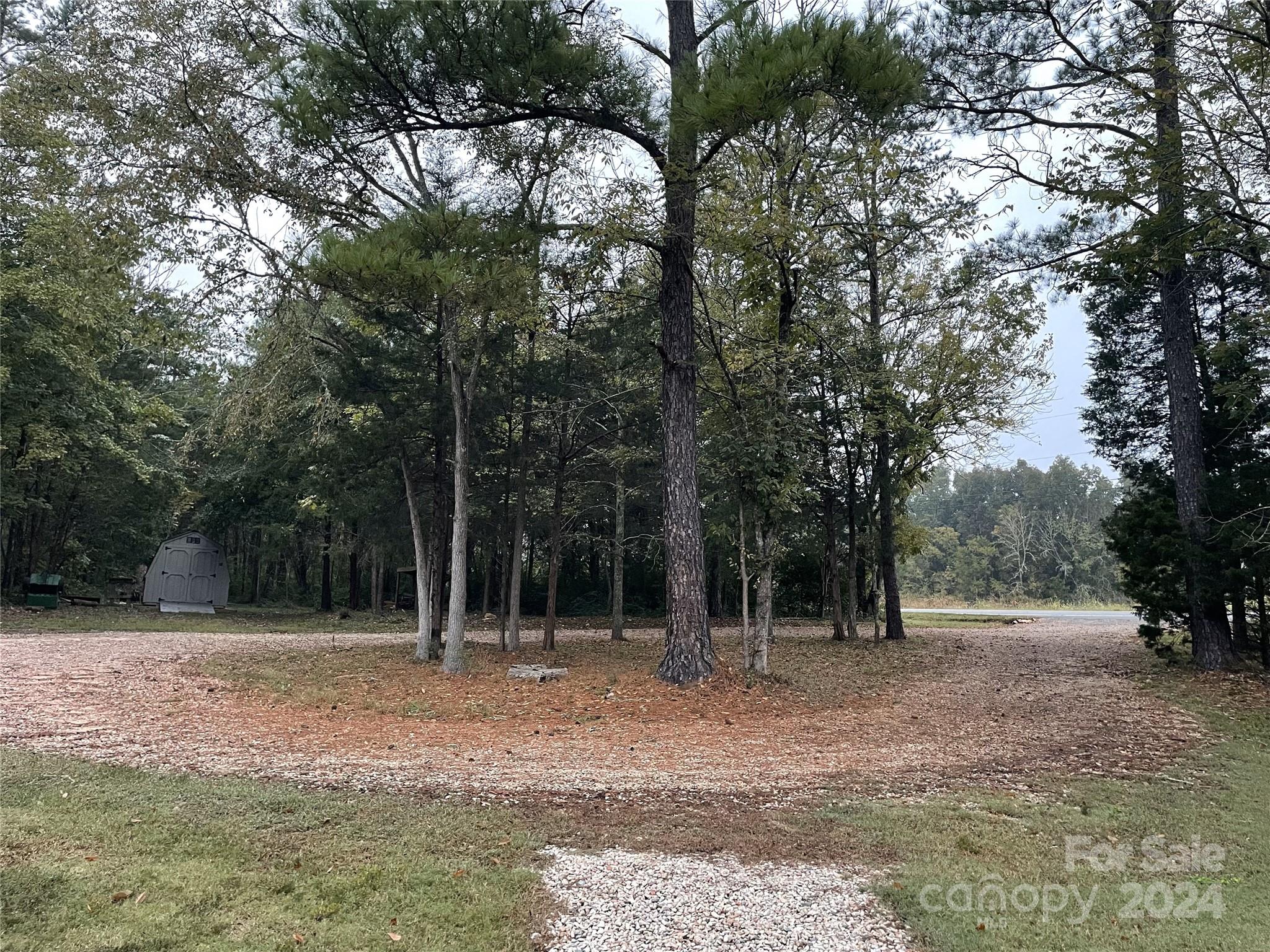 3000 Penninger Road Concord, NC 28025 - Photo 2 of 48 a backyard of a house with trees and entertaining space
