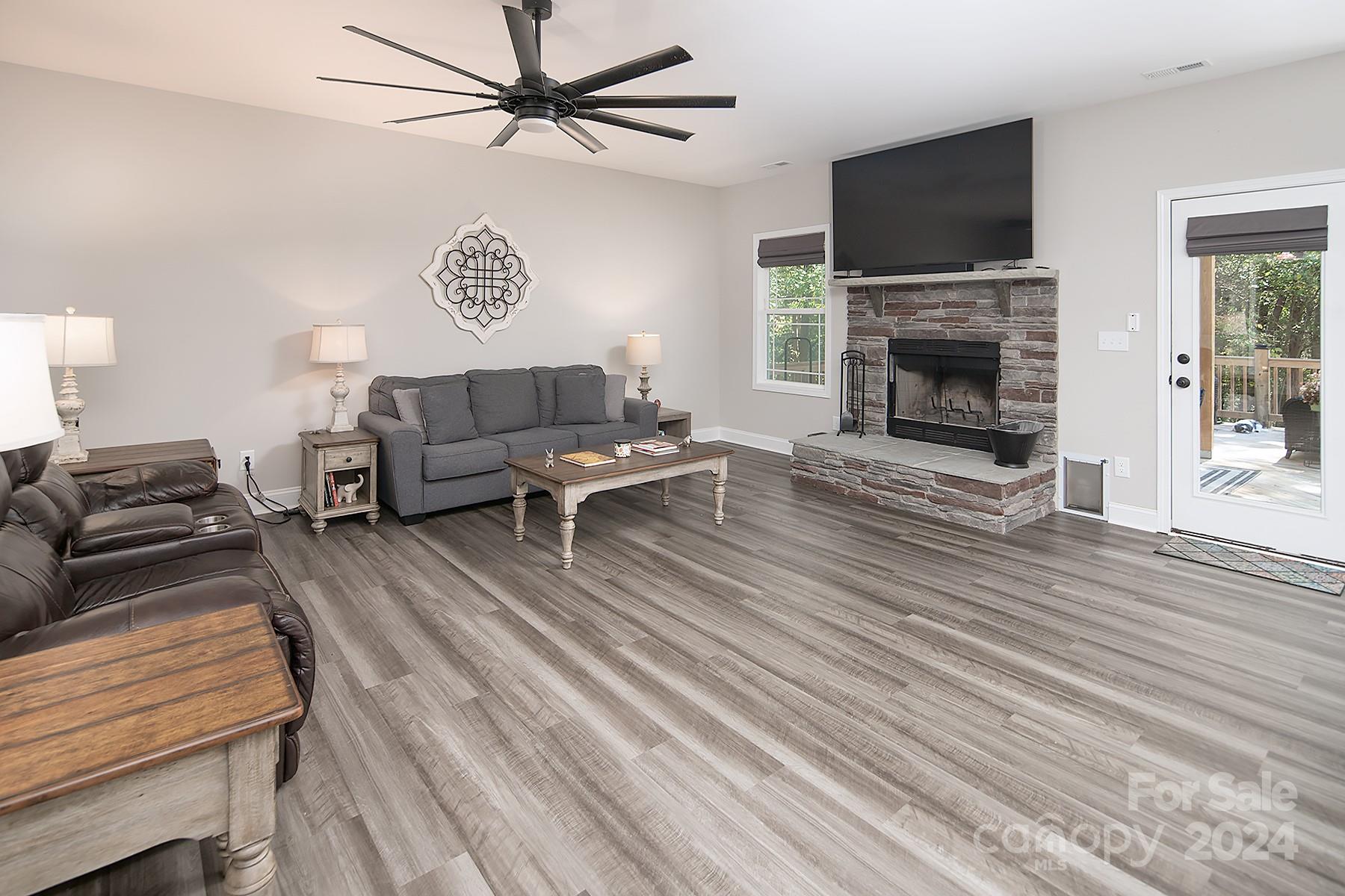 3000 Penninger Road Concord, NC 28025 - Photo 23 of 48 a living room with furniture a flat screen tv and a fireplace