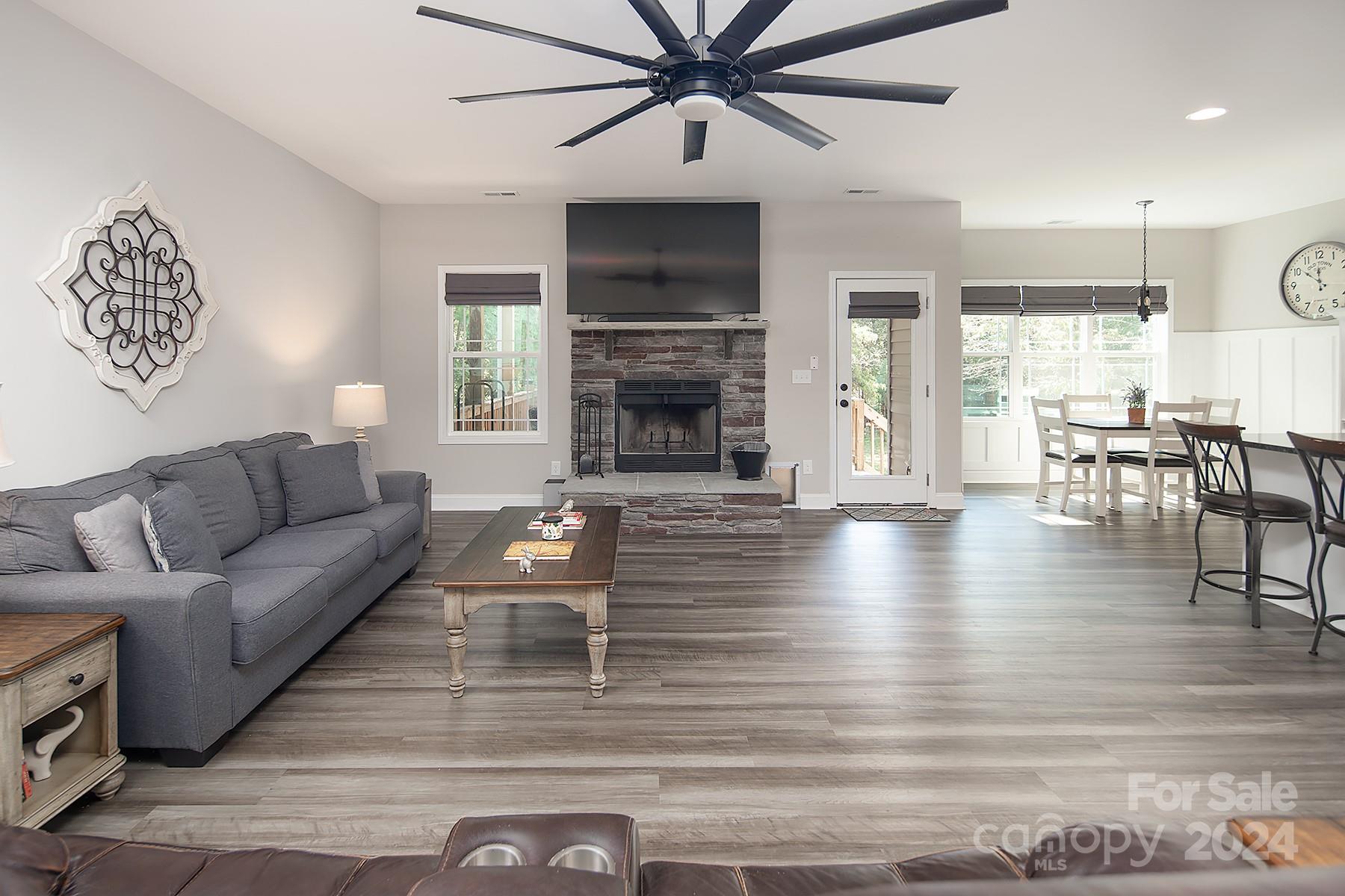 3000 Penninger Road Concord, NC 28025 - Photo 24 of 48 a living room with furniture wooden floor and a fireplace