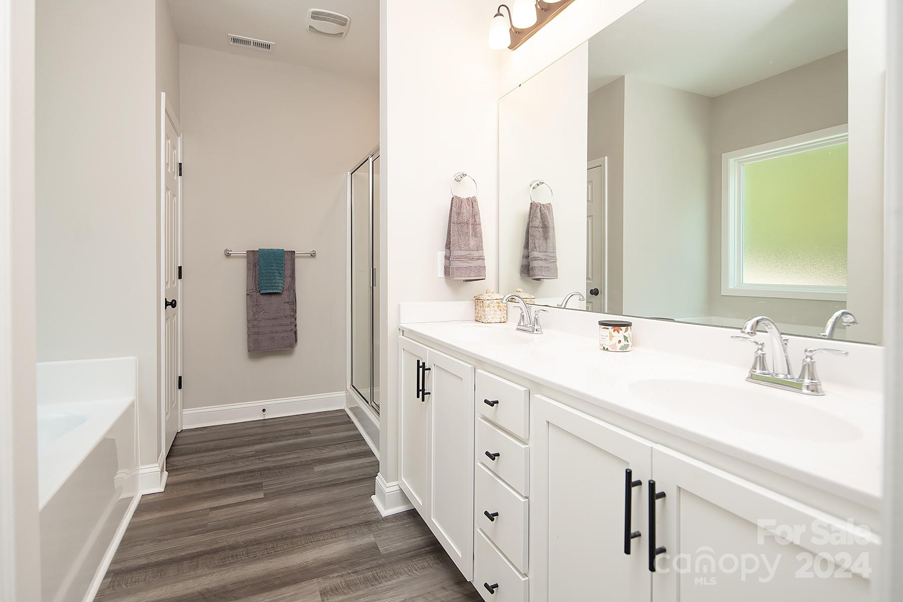 3000 Penninger Road Concord, NC 28025 - Photo 34 of 48 a spacious bathroom with double vanity and a bathtub