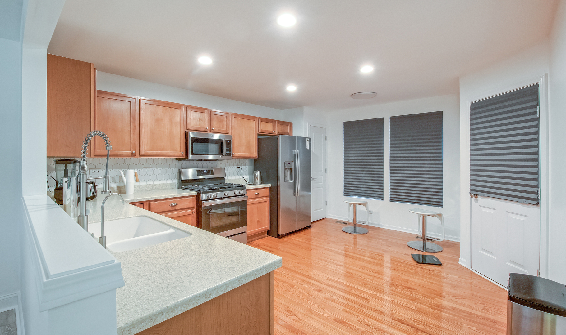 2804 Neubauer Circle Lindenhurst, IL 60046 - Photo 6 of 26 a kitchen with stainless steel appliances granite countertop a sink refrigerator and microwave