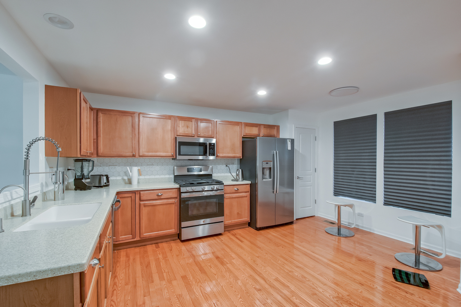 2804 Neubauer Circle Lindenhurst, IL 60046 - Photo 8 of 26 a kitchen with stainless steel appliances granite countertop a sink refrigerator and cabinets