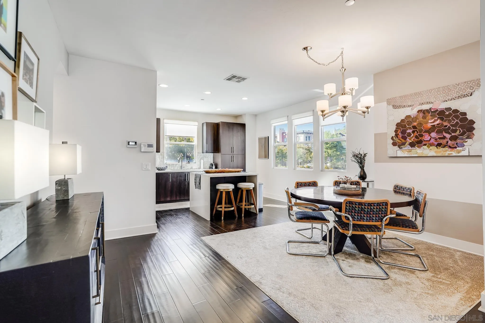 7803 Inception Way San Diego, CA 92108 - Photo 16 of 37 a workspace with furniture a kitchen and chandelier