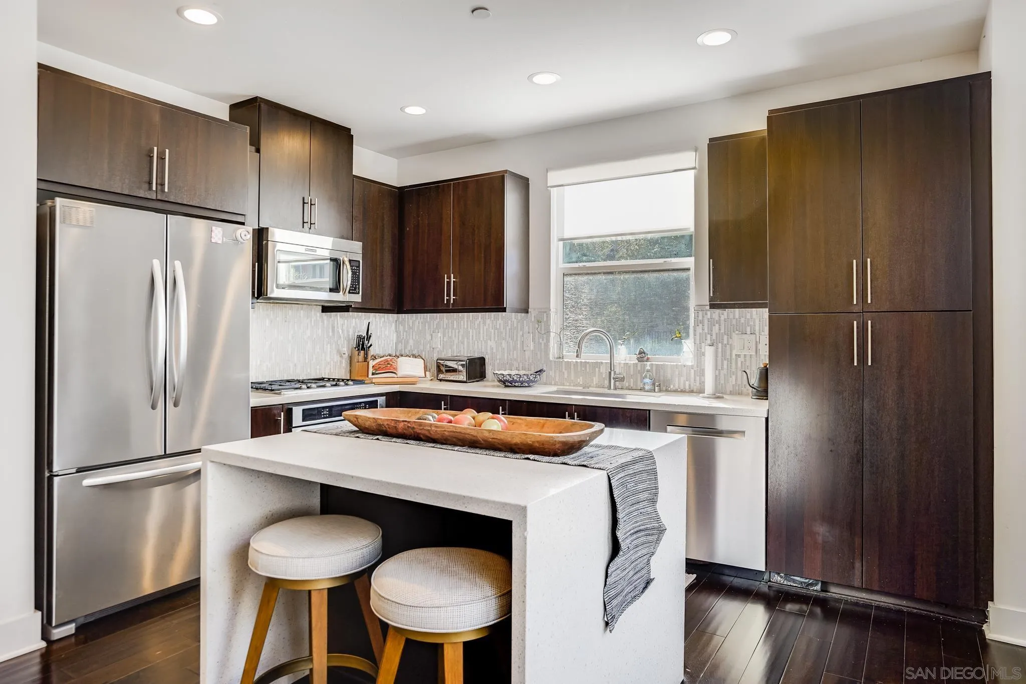7803 Inception Way San Diego, CA 92108 - Photo 17 of 37 a kitchen with granite countertop a refrigerator and a sink