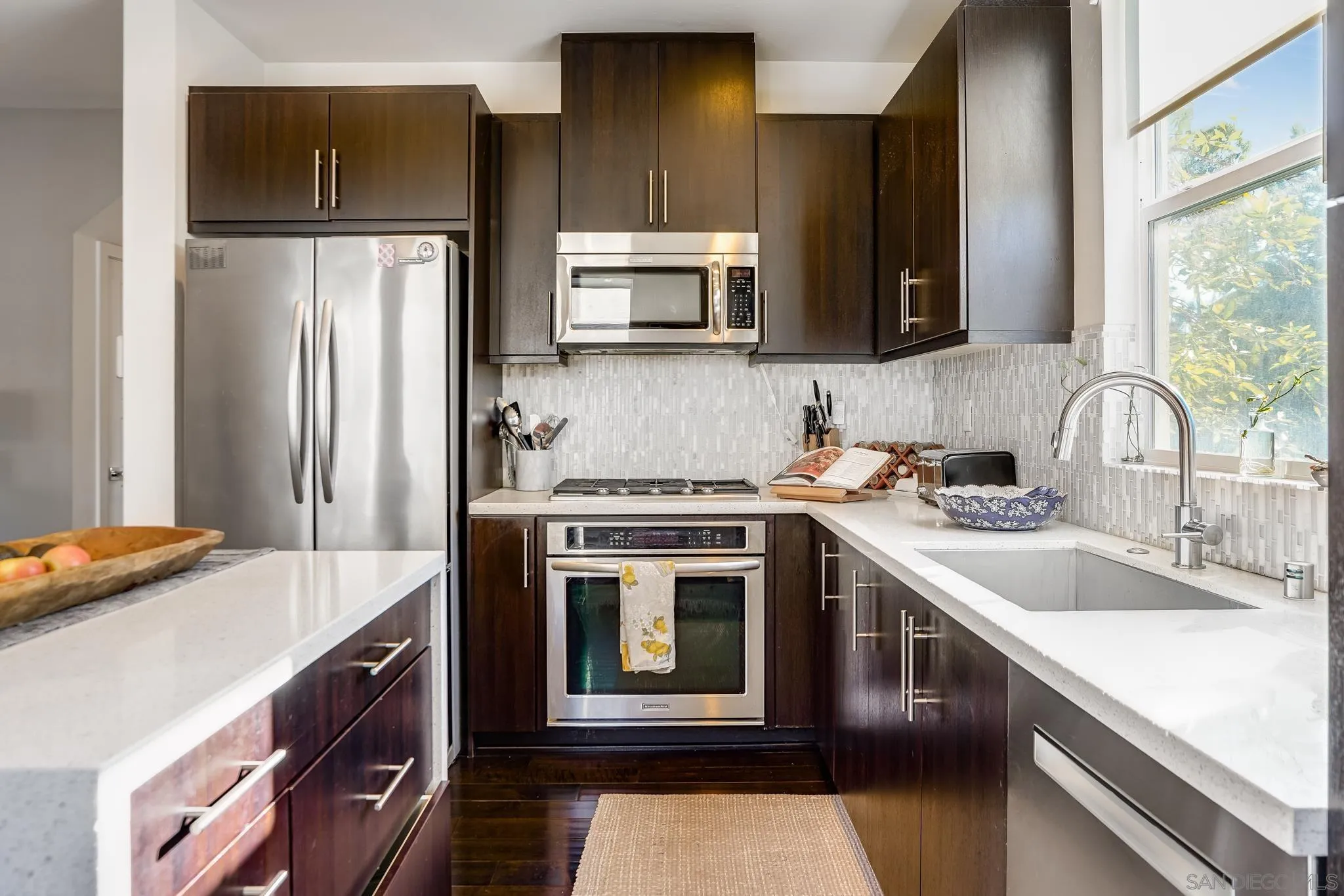7803 Inception Way San Diego, CA 92108 - Photo 18 of 37 a kitchen with stainless steel appliances granite countertop a sink stove and refrigerator