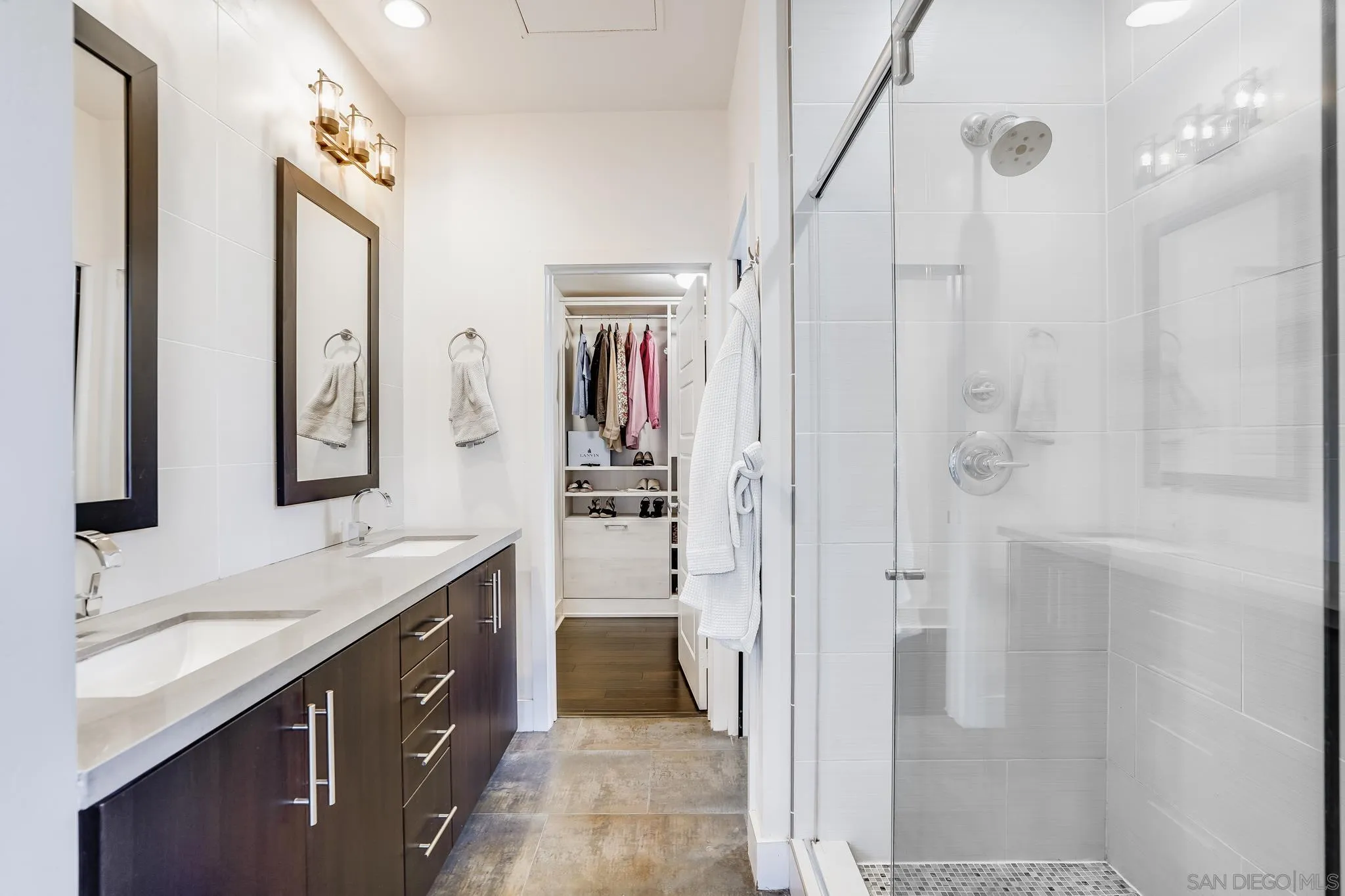 7803 Inception Way San Diego, CA 92108 - Photo 21 of 37 a spacious bathroom with a granite countertop sink a mirror a vanity and a shower