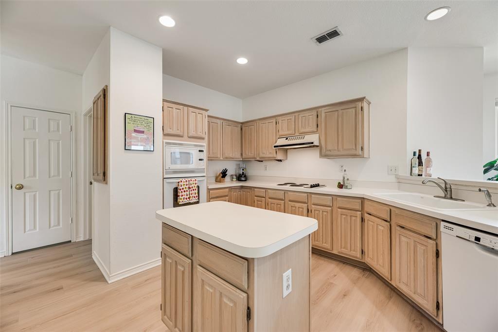 1406 West Peters Colony Road Carrollton, TX 75007 - Photo 6 of 29 a kitchen with a sink stove and refrigerator