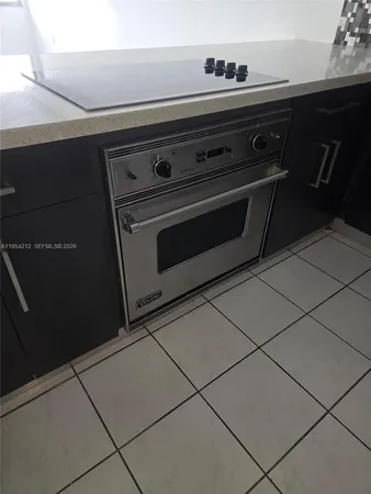 a view of a livingroom with kitchen and furniture