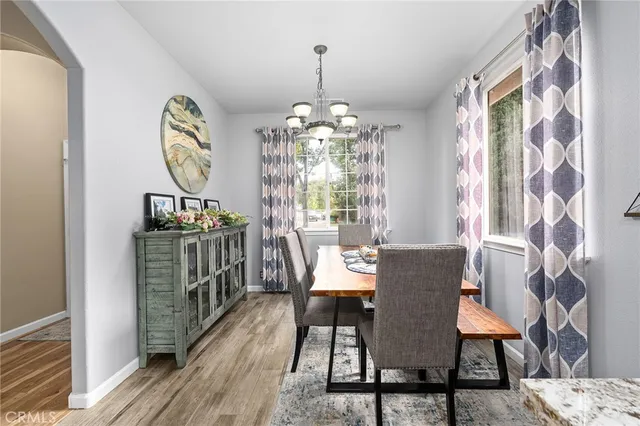 a view of a dining room with furniture and chandelier
