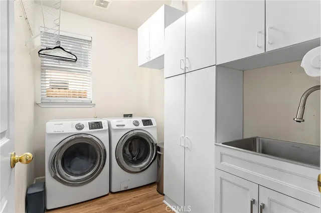 a utility room with sink dryer and washer