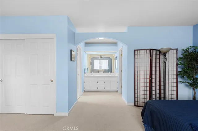 a view of a bedroom with furniture and window