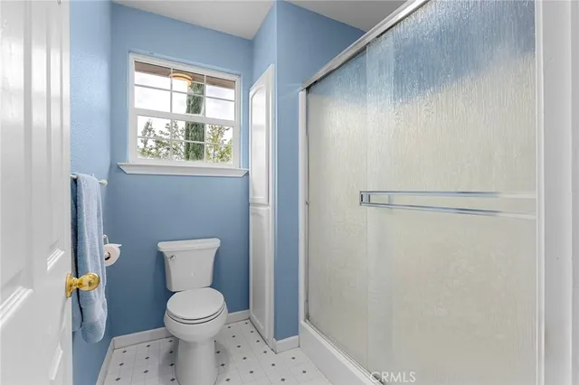 a bathroom with a toilet and a shower
