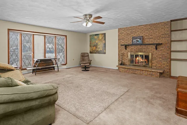 a living room with furniture and a floor to ceiling window