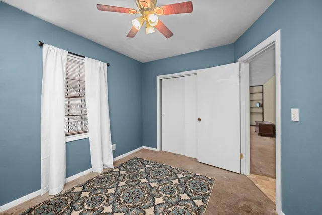 a view of a bedroom with wooden floor and closet