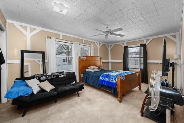 a living room with furniture gym equipment and a flat screen tv