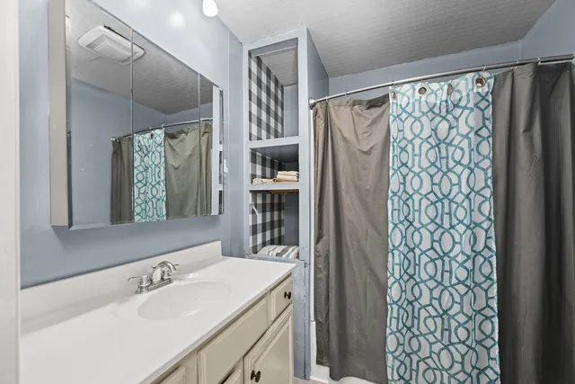 a bathroom with a sink and a mirror