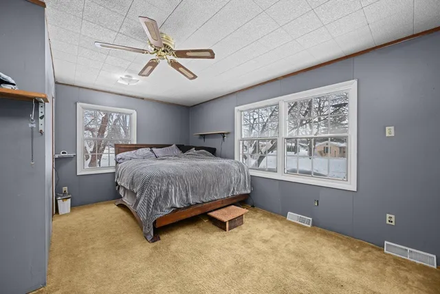 a bedroom with a bed and window