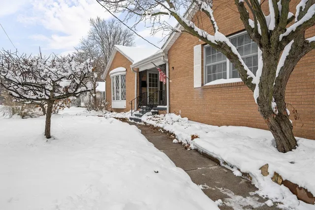 a view of a house with snow on the road