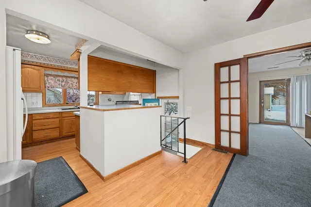 a view of a kitchen with furniture and wooden floor