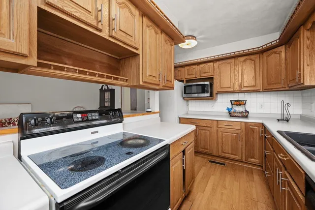 a kitchen with stainless steel appliances granite countertop a stove and a sink