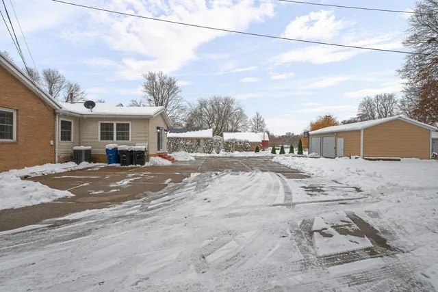 a view of a house with a snow on the road