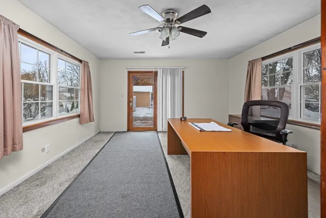 a room with furniture a ceiling fan and a window
