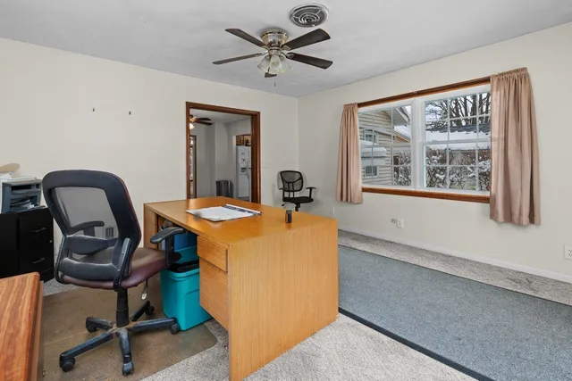 a dining room with furniture and window