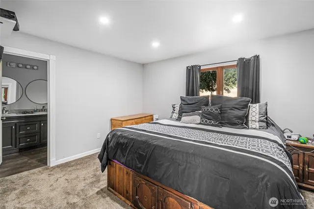 a bedroom with a bed and dresser