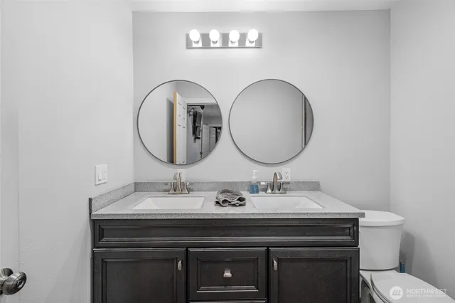 a bathroom with a toilet a sink and a mirror