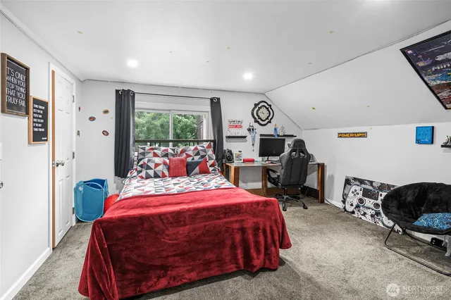 a bedroom with bed and a large window