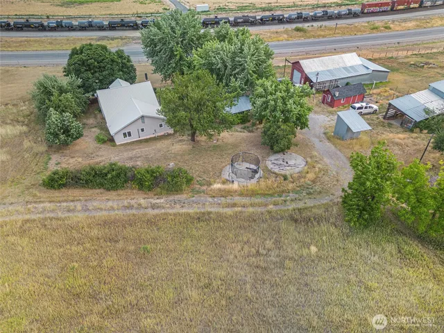 a view of a street with a bench and trees