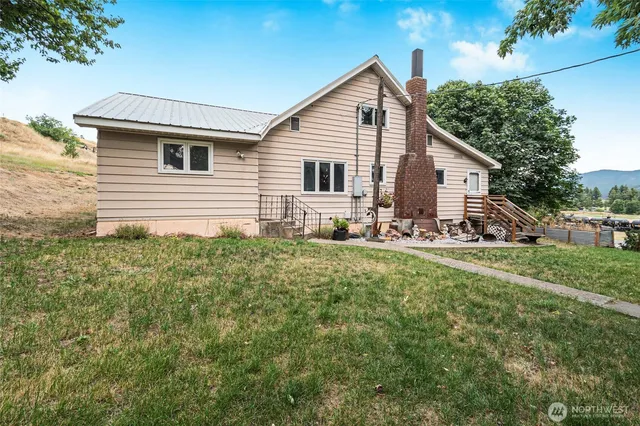 a view of a house with a chairs in a yard