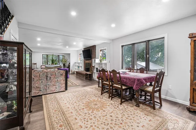 a dining room with furniture and wooden floor