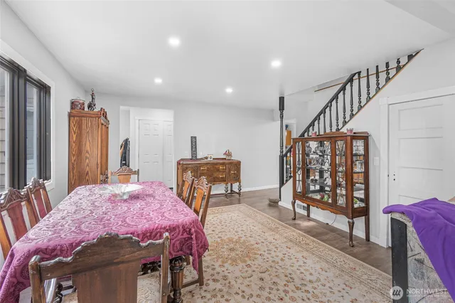 a living room with furniture a wooden floor and a book shelf