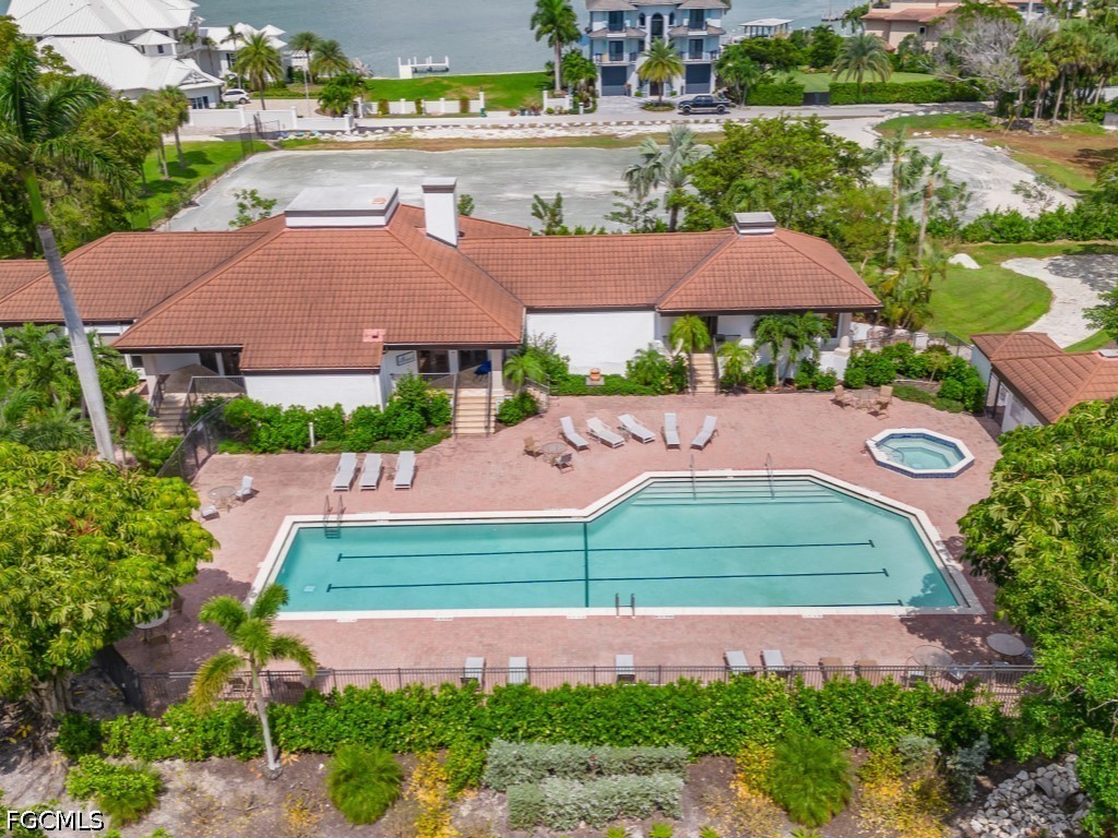 232 La Peninsula Boulevard, Unit 232 Naples, FL 34113 - Photo 38 of 44 an aerial view of a house with garden space and street view
