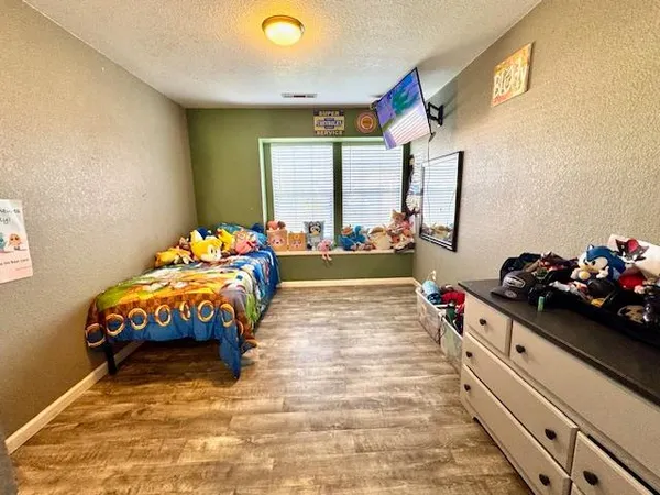 a bedroom with a bed and a dresser