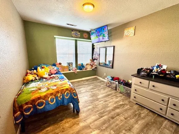 a bedroom with a bed and a dresser