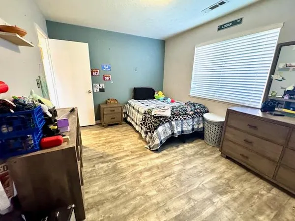 a bedroom with a bed and a flat tv screen