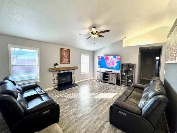a kitchen with stainless steel appliances granite countertop a sink and a refrigerator