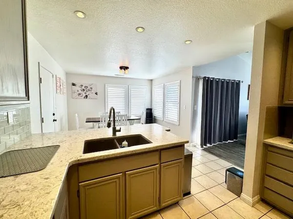 a view of a dining room kitchen counter and chairs