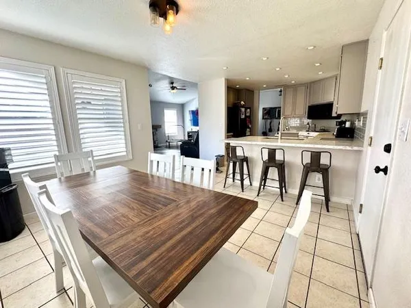 a living room with a table and a chair