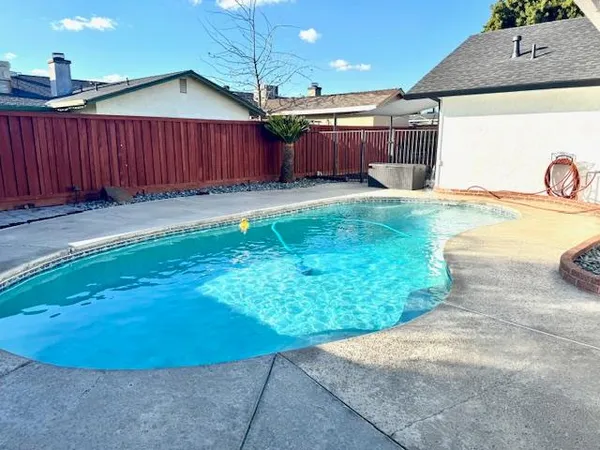 a view of a swimming pool with chairs