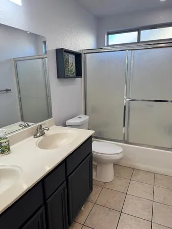a view of a hallway with wooden floor and windows